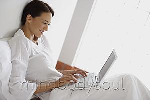 Mind Body Soul - Woman in bed on laptop