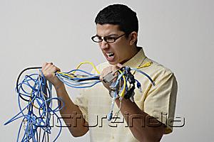 PictureIndia - Frustrated man with tangled wires