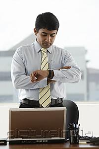 PictureIndia - business man looking at his watch