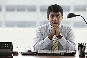 PictureIndia - business man resting chin in folded hands