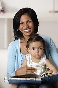 PictureIndia - woman flipping picture book with baby