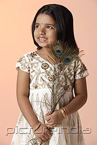 PictureIndia - Little girl wearing traditional Indian clothing holding peacock feathers