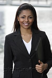 PictureIndia - woman wearing business suit, holding folder