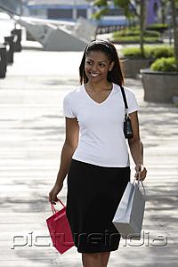 PictureIndia - woman walking outside holding shopping bags