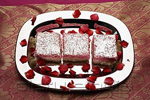 PictureIndia - Indian pink sweets on silver tray with rose petals.