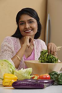 PictureIndia - Indian woman smiling while preparing food