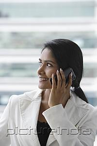 PictureIndia - profile of an Indian woman talking on phone and smiling.