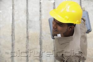 PictureIndia - Top view of man wearing construction hat and walking