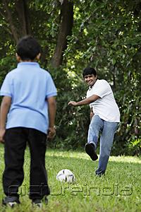 PictureIndia - Father kicking ball to son
