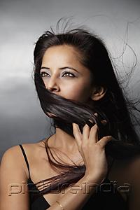 PictureIndia - head shot of woman with hair blowing around her face
