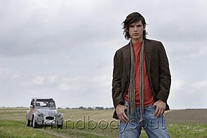 Mind Body Soul - Young man standing near car