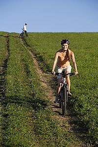 Mind Body Soul - Young woman riding bicycle away from young man