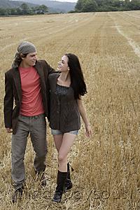 Mind Body Soul - Young couple walking through field