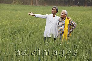 Asia Images Group - father and son farmers in field