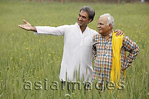 Asia Images Group - father and son farmers in field