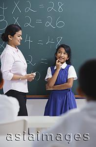 Asia Images Group - teacher and girl at chalkboard