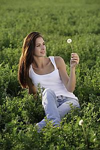 Mind Body Soul - young woman holding dandelion