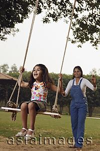 Asia Images Group - mom pushing daughter in swing
