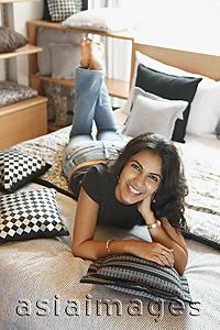 Asia Images Group - young woman on bed