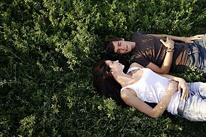 Mind Body Soul - Young couple lying on back in field