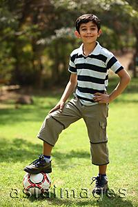 Asia Images Group - Boy with foot on soccer ball