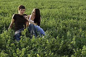 Mind Body Soul - Young couple sitting in field