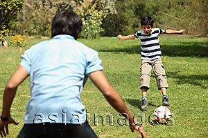 Asia Images Group - Father and son playing soccer