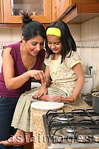 Asia Images Group - Mom and daughter making bread