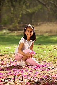 Asia Images Group - young girl kneeling in park