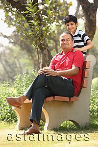 Asia Images Group - Father on bench, son standing