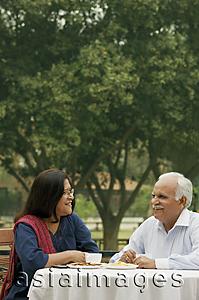 Asia Images Group - senior couple having coffee outdoors