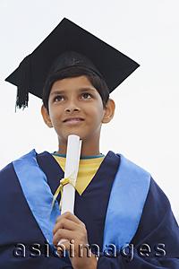 Asia Images Group - young boy graduate with diploma on chin