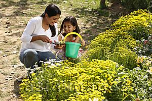 Asia Images Group - Mother and daughter with green pail