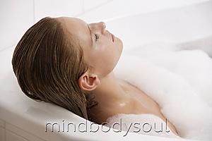 Mind Body Soul - Profile of woman reclining in bath tub