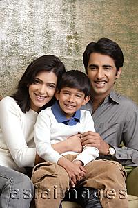 Asia Images Group - family of three smiling at camera (vertical)