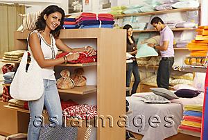 Asia Images Group - girl in store, couple in background