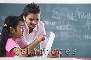 Asia Images Group - teacher and student at laptop, girl pointing at screen