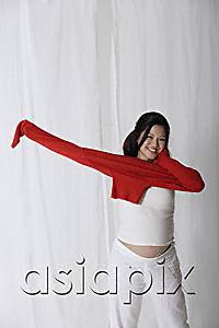 AsiaPix - Pregnant woman putting on red sweater