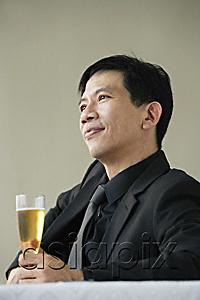 AsiaPix - Man enjoying glass of champagne