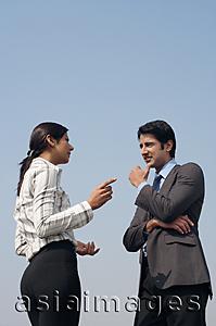 Asia Images Group - woman and man discussing business (vertical)