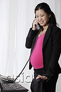 AsiaPix - Profile of pregnant businesswoman on phone