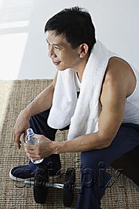 AsiaPix - Man drinking water after workout