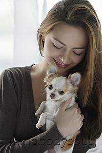 Mind Body Soul - Young woman holding chihuahua