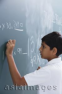Asia Images Group - boy at chalkboard (side view)