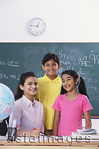Asia Images Group - teacher with two students, all smiling at camera