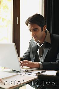 Asia Images Group - business man working at laptop