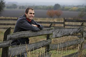 Mind Body Soul - Young man leaning on country fence