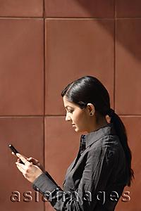 Asia Images Group - woman reading messages (vertical)