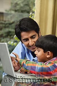 Asia Images Group - father and son work at laptop