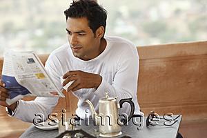 Asia Images Group - man reading newspaper